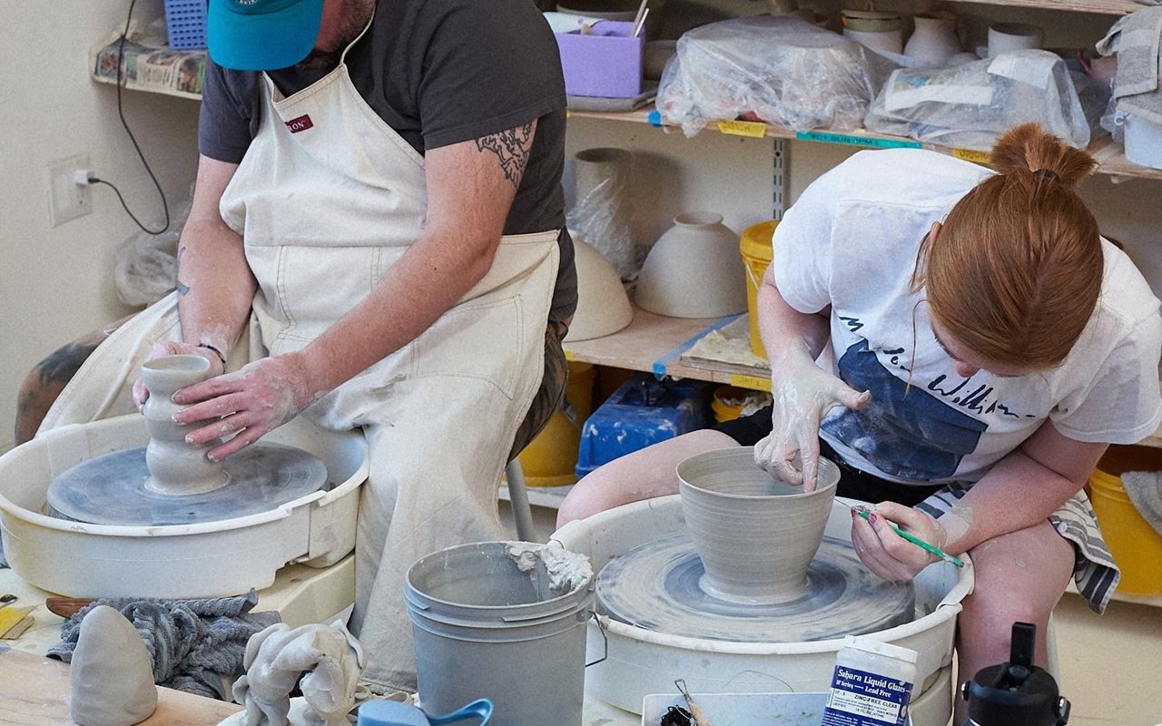 Students at the pottery wheel at Clay Space